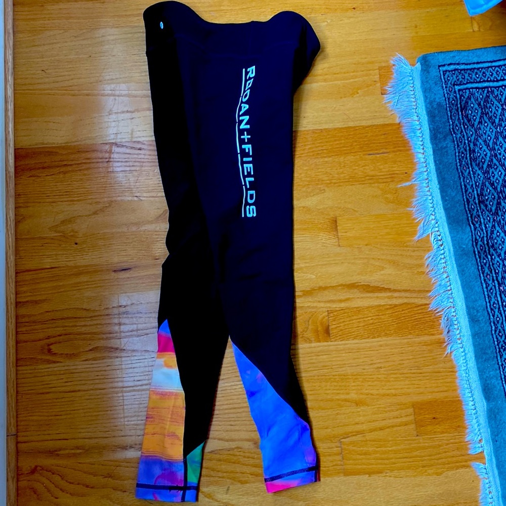 Black leggings with rainbow on the calves.